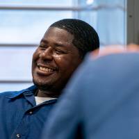 Student smiling at desk